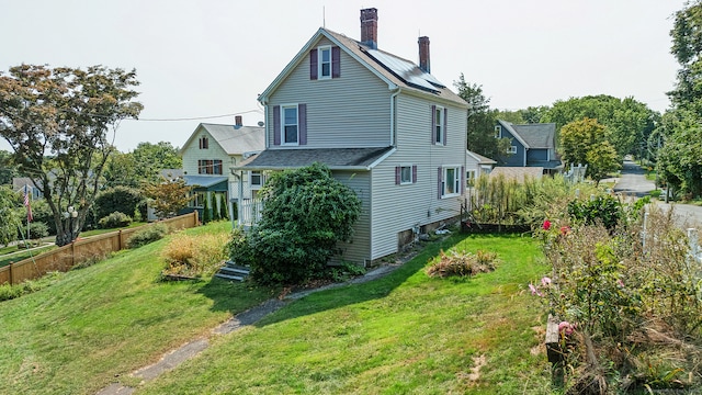 rear view of property with a yard