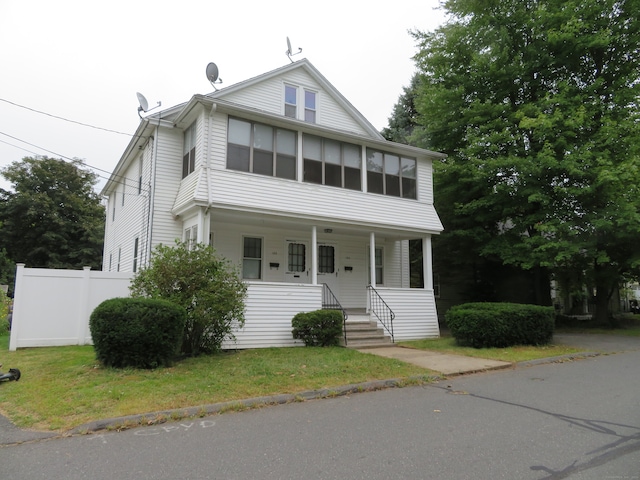 view of front of home featuring a porch and a front yard