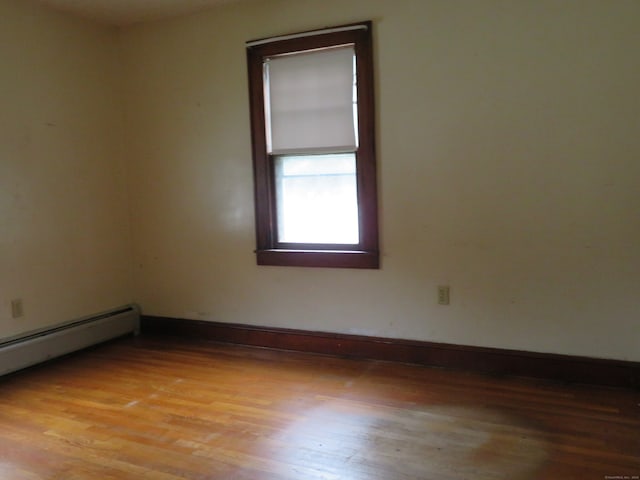 empty room featuring light hardwood / wood-style floors and baseboard heating