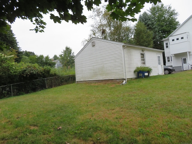 view of property exterior featuring a lawn