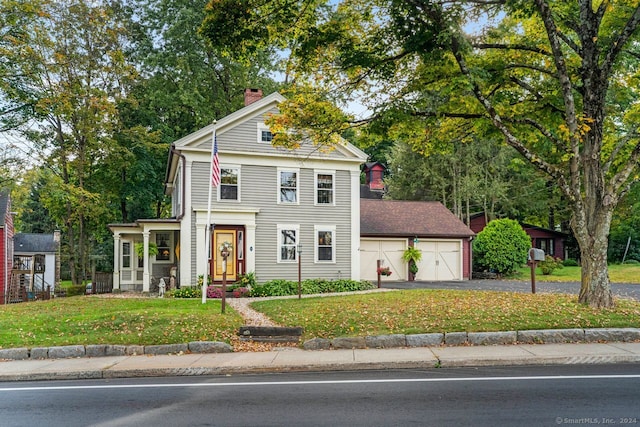 view of front facade with a front yard and a garage