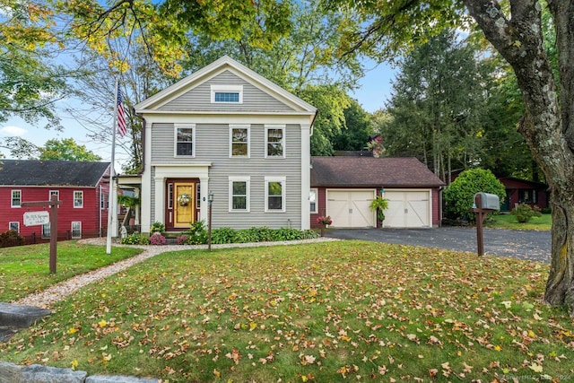 greek revival house with a garage and a front lawn