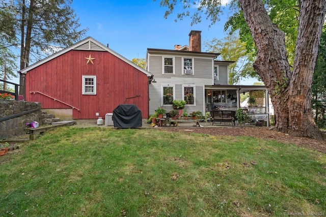 rear view of property with a lawn