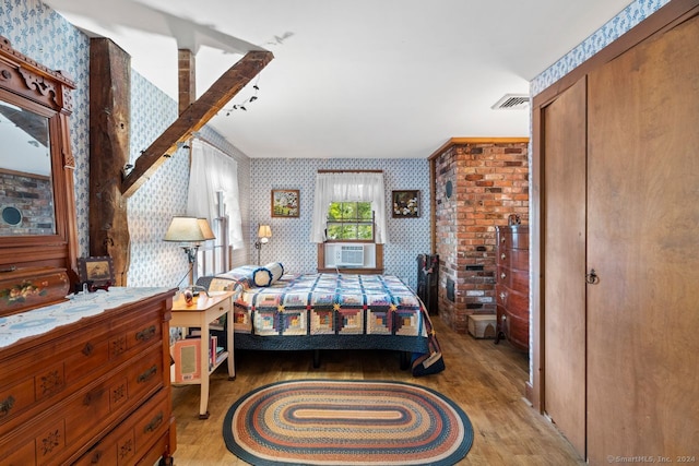 bedroom with a closet and light hardwood / wood-style floors