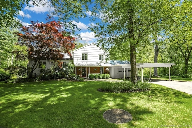 exterior space with a carport and a yard