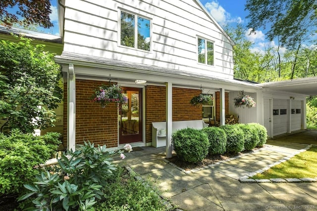 doorway to property with a garage