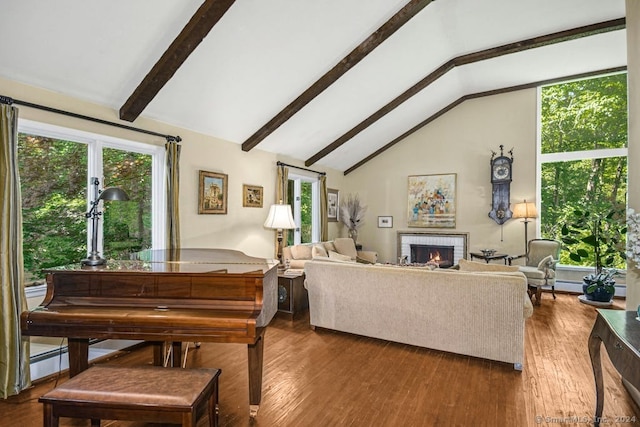 living room with wood-type flooring, a brick fireplace, and vaulted ceiling with beams