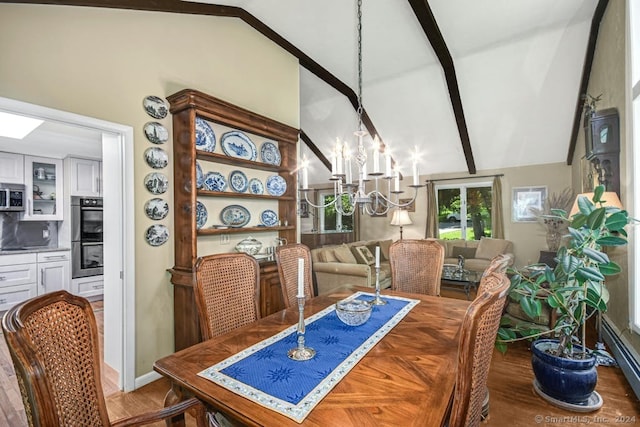 dining space with an inviting chandelier, hardwood / wood-style flooring, and lofted ceiling with beams