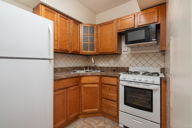 kitchen featuring sink, white appliances, and tasteful backsplash