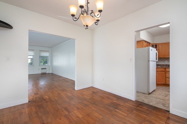 interior space featuring an inviting chandelier, radiator, and dark hardwood / wood-style floors