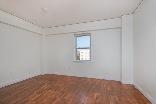 unfurnished room with dark hardwood / wood-style flooring