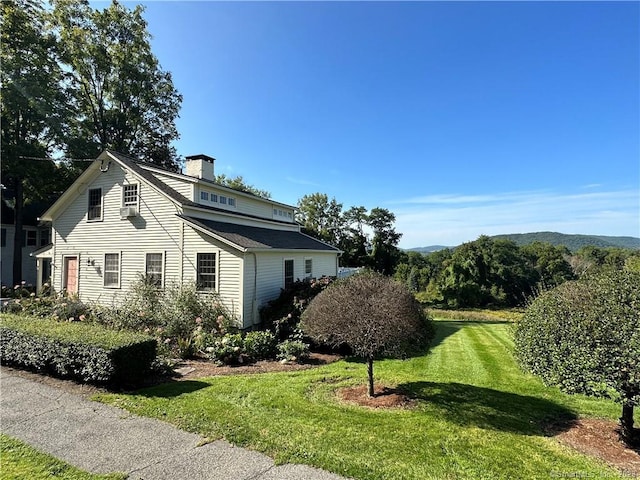 view of property exterior featuring a lawn