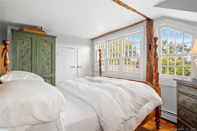 bedroom featuring a baseboard radiator and wood-type flooring