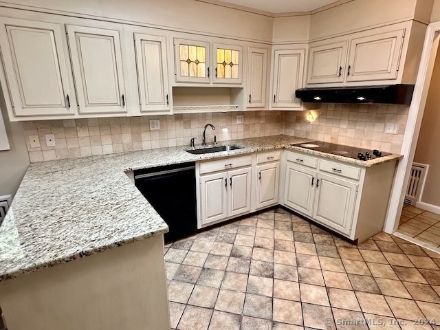 kitchen featuring sink, white cabinetry, black appliances, backsplash, and light stone countertops