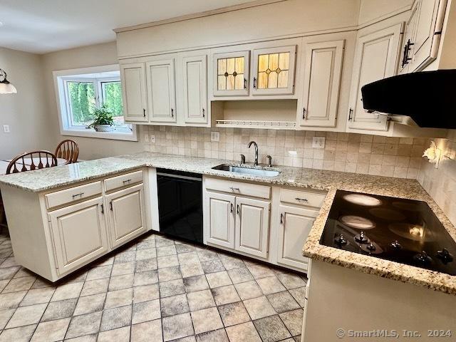 kitchen featuring white cabinets, kitchen peninsula, black appliances, sink, and extractor fan