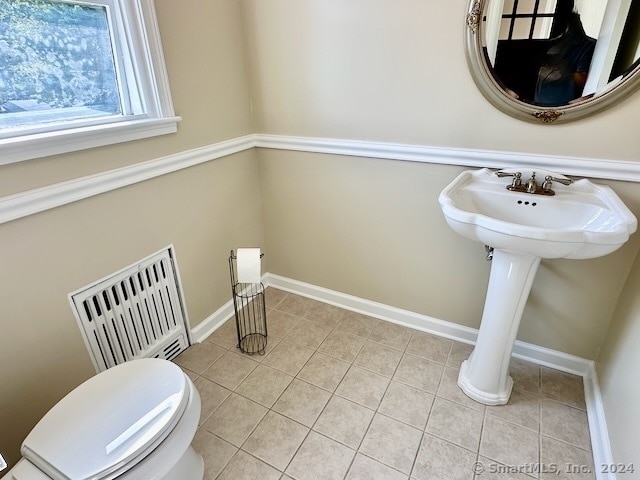 bathroom featuring tile patterned flooring and toilet