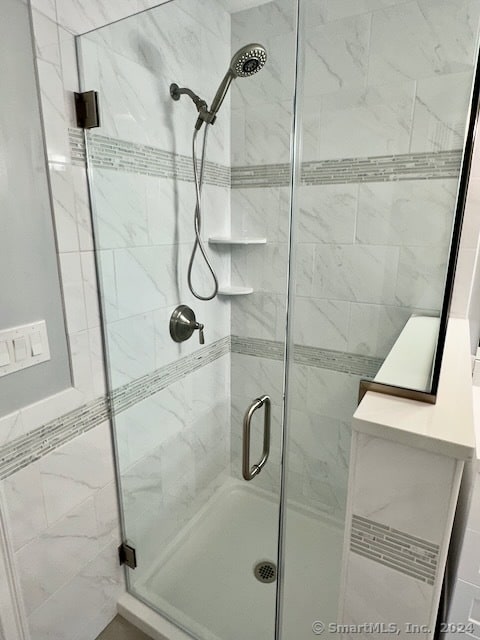 bathroom featuring an enclosed shower