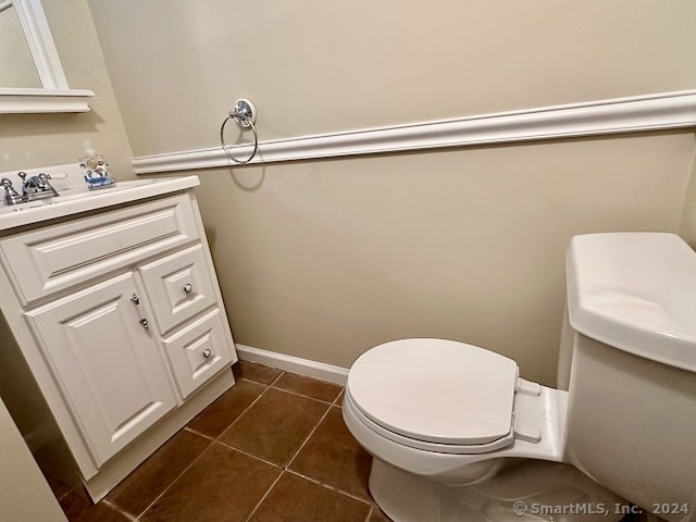 bathroom with tile patterned flooring, vanity, and toilet