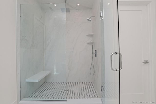 bathroom with a shower with door