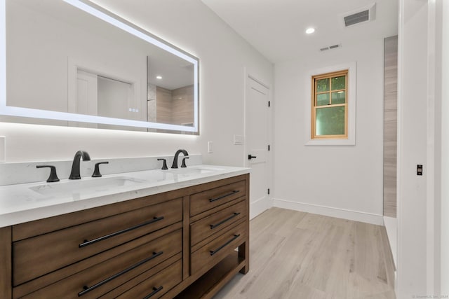 bathroom with vanity and hardwood / wood-style flooring