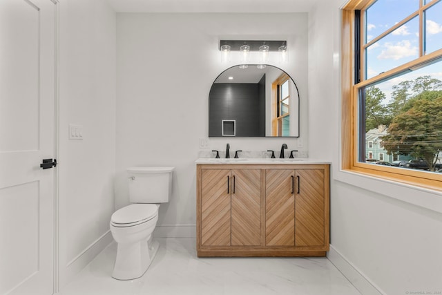 bathroom featuring toilet and vanity