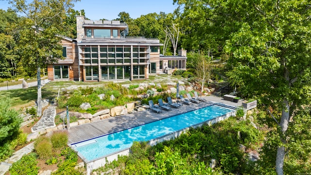 back of property featuring a sunroom and a patio area