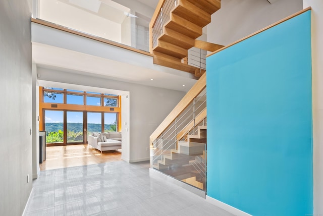 274 Joshuatown Rd, Lyme, CT 06371 - staircase featuring a towering ceiling and baseboards