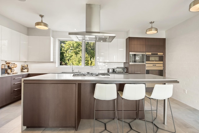 274 Joshuatown Rd, Lyme, CT 06371 - kitchen featuring island range hood, modern cabinets, stainless steel appliances, a sink, and a kitchen island