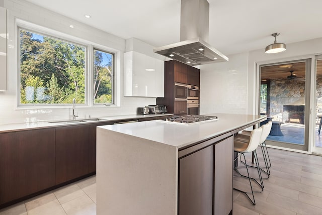 274 Joshuatown Rd, Lyme, CT 06371 - kitchen featuring island range hood, modern cabinets, a sink, tasteful backsplash, and appliances with stainless steel finishes