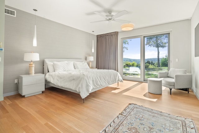 bedroom with ceiling fan and light wood-type flooring