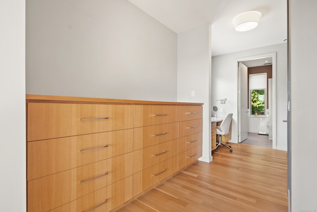 hallway with light hardwood / wood-style floors