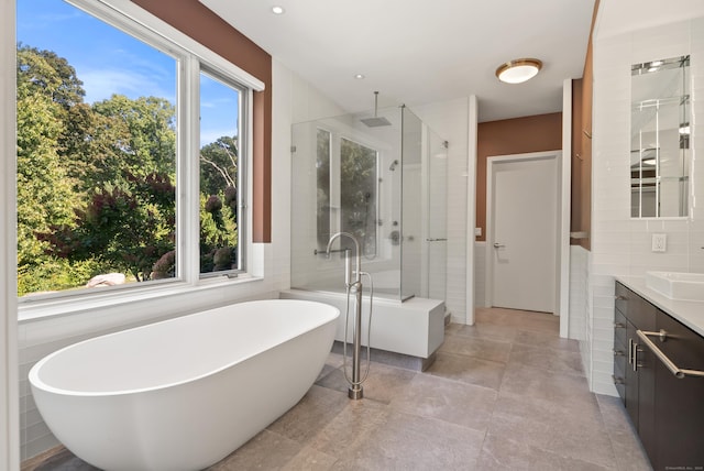 274 Joshuatown Rd, Lyme, CT 06371 - bathroom featuring vanity, a stall shower, tile walls, a freestanding tub, and a fireplace
