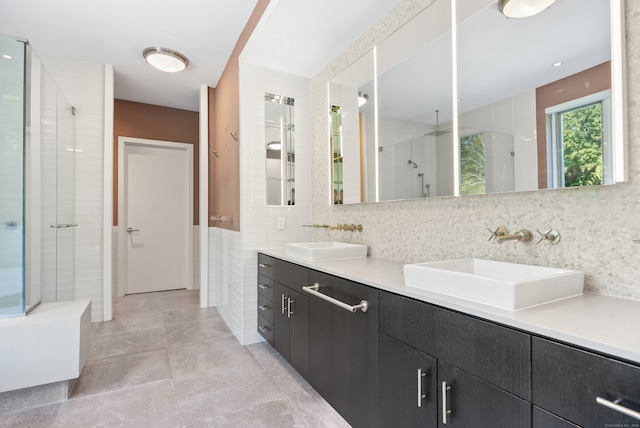 bathroom featuring tile walls, vanity, decorative backsplash, and an enclosed shower