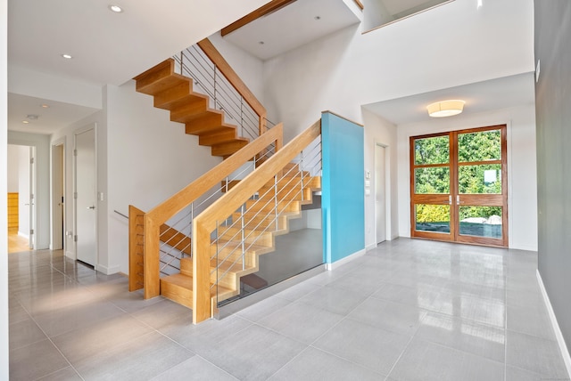 274 Joshuatown Rd, Lyme, CT 06371 - stairway with baseboards, tile patterned flooring, a towering ceiling, and recessed lighting