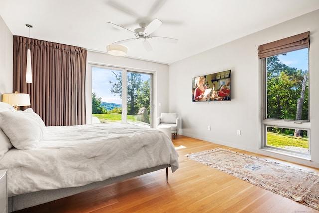 bedroom with ceiling fan and hardwood / wood-style flooring