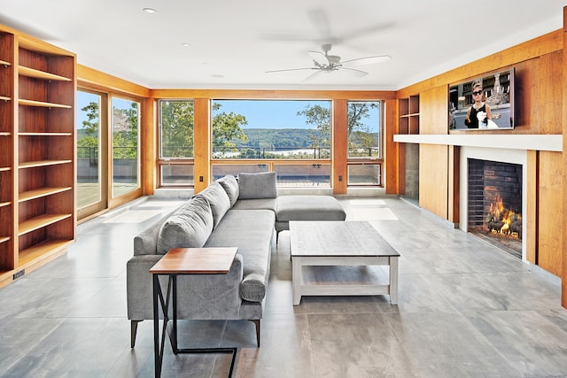 274 Joshuatown Rd, Lyme, CT 06371 - living area with a lit fireplace, a ceiling fan, and plenty of natural light
