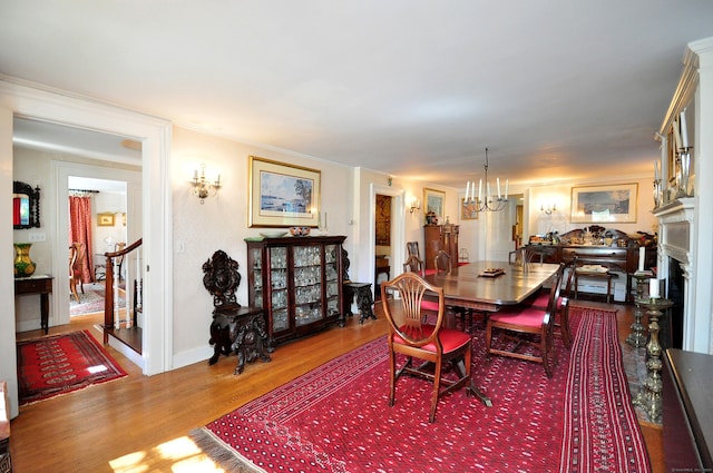 dining area with an inviting chandelier and hardwood / wood-style flooring