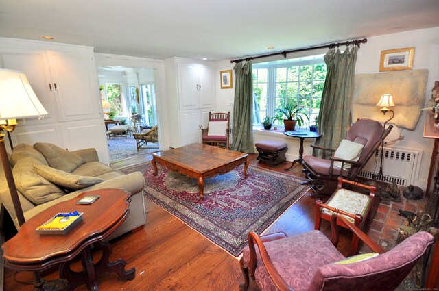 living room with radiator and hardwood / wood-style flooring