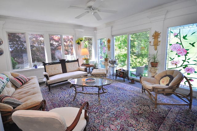 sunroom with ceiling fan and a baseboard radiator