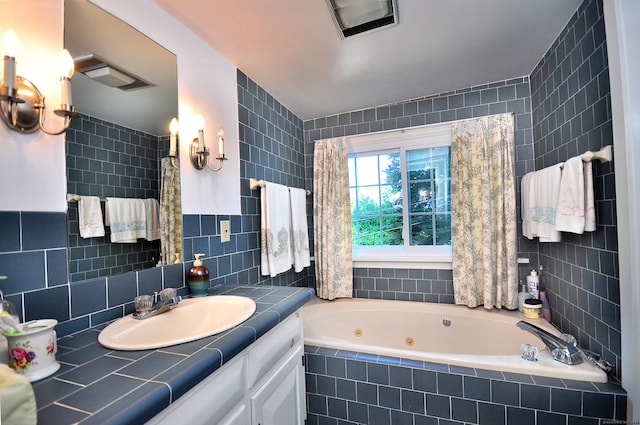 bathroom featuring vanity, tiled bath, and tile walls