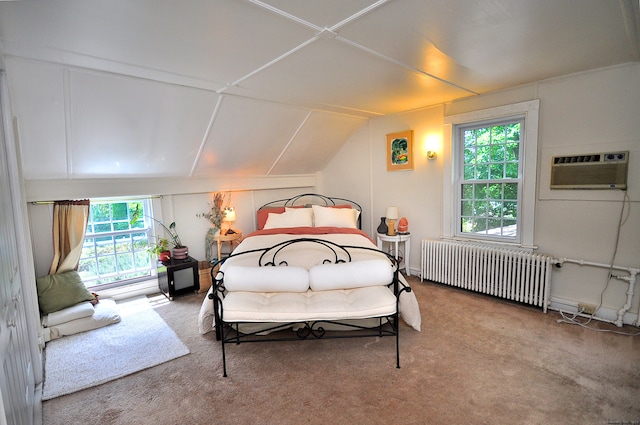 bedroom with radiator, vaulted ceiling, carpet, and an AC wall unit