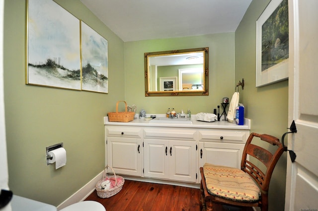 bathroom featuring wood-type flooring, vanity, and toilet