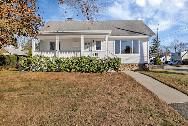 bungalow-style home featuring a porch and a front lawn