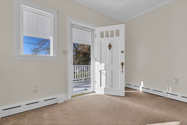 interior space with carpet flooring, crown molding, and a baseboard heating unit