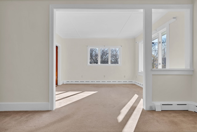 carpeted empty room with a baseboard heating unit