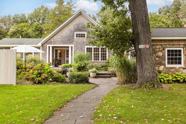 rear view of property with a lawn