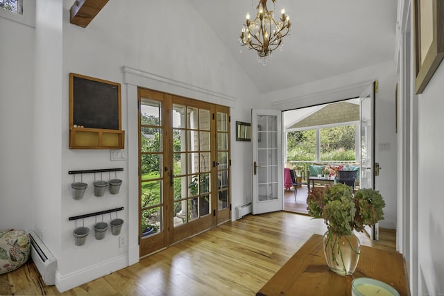 doorway featuring a baseboard heating unit, light hardwood / wood-style flooring, high vaulted ceiling, and french doors