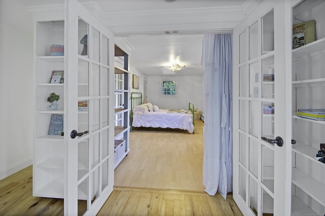 bedroom with french doors and hardwood / wood-style flooring