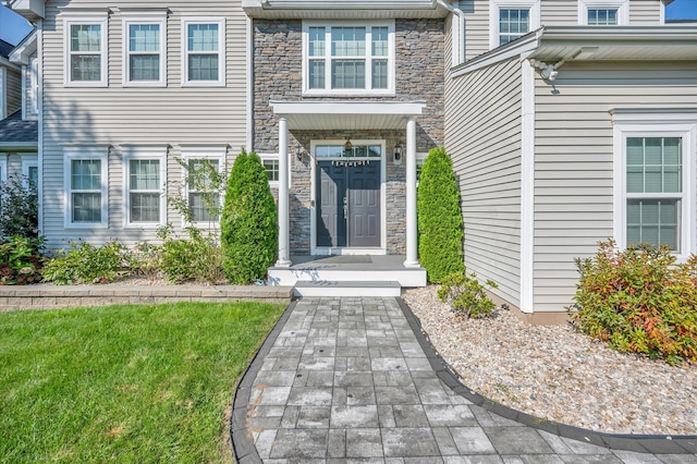 doorway to property featuring a yard