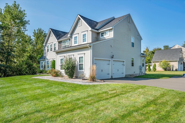 exterior space with a garage and a lawn